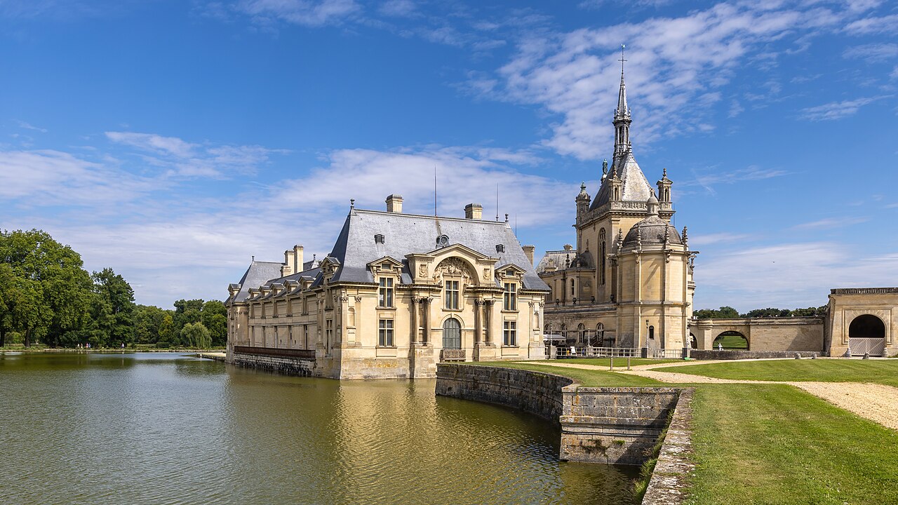 Exterior view of the Château de Chantilly under blue sky Oise France